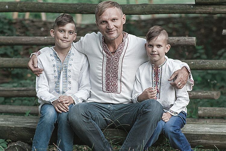 Oleh Skrypka hugs his sons